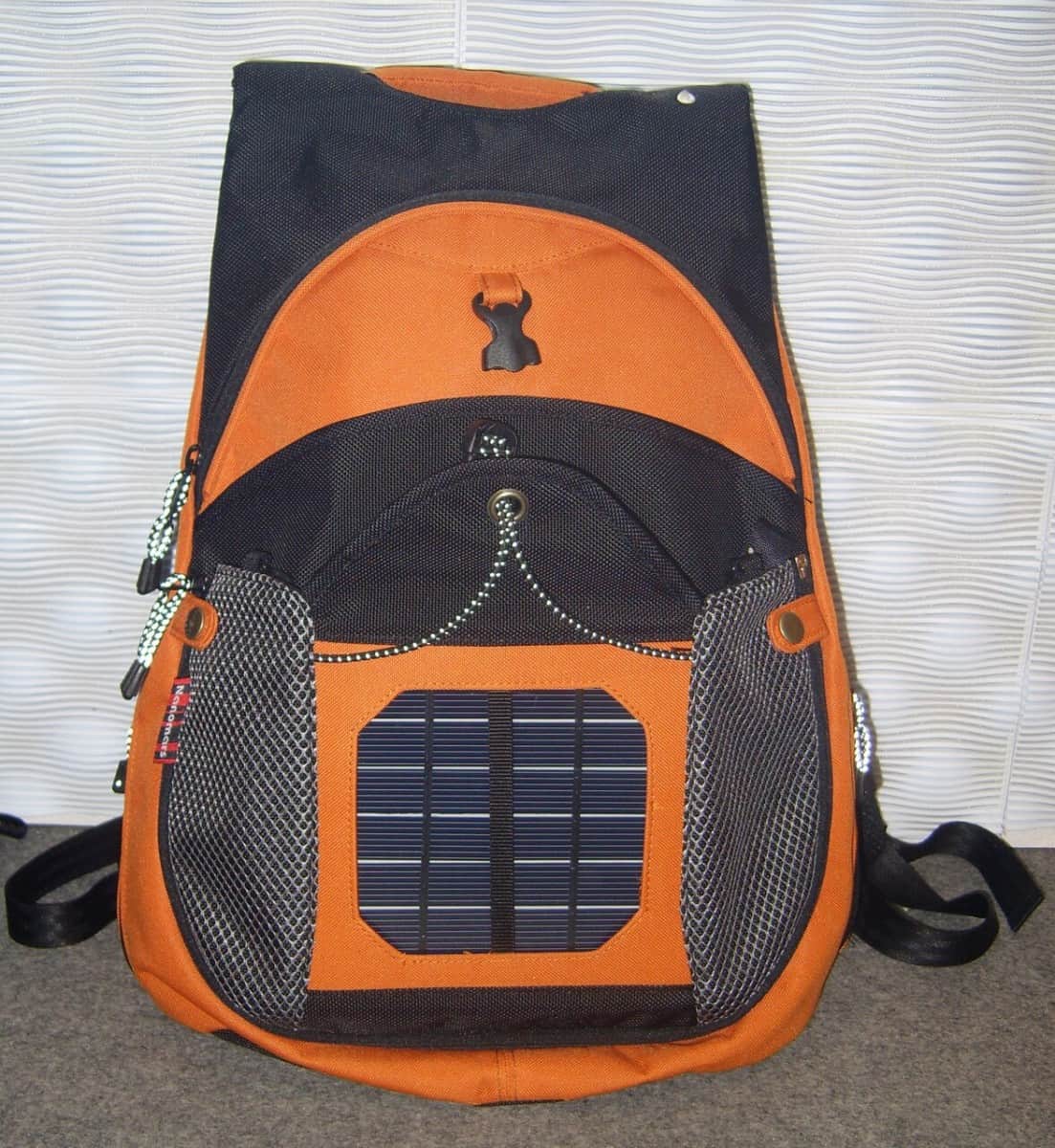orange solar backpack on carpet